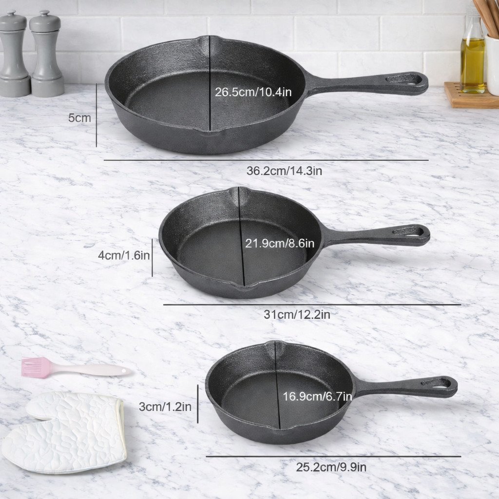 Three cast iron skillets with measurements on a marble countertop